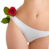 A fragment of woman  body in white panties and rose